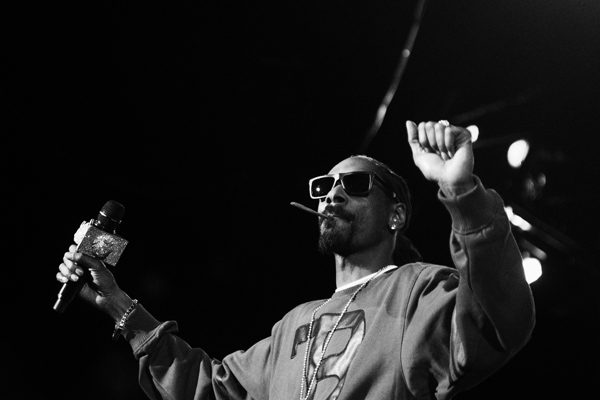 Rapper performing on stage with sunglasses.