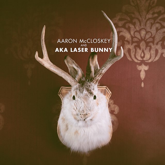 Rabbit with antlers on ornate background.