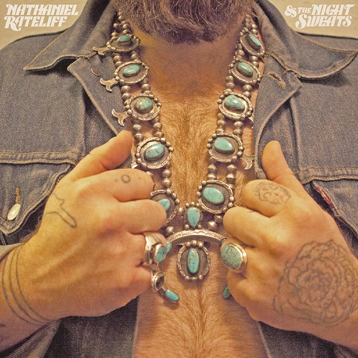 Man wearing turquoise jewelry and denim jacket.