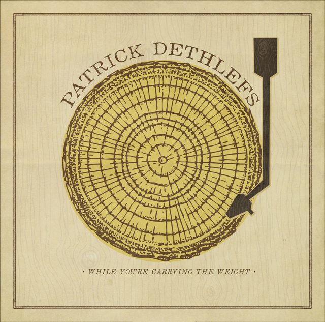 Tree ring and arrow on album cover.