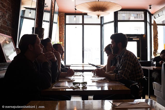 People dining in a dimly lit restaurant.