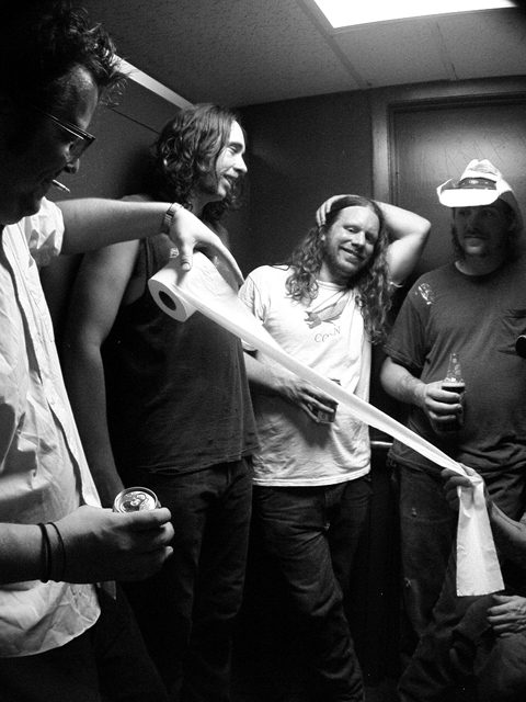 Group of men with toilet paper roll.