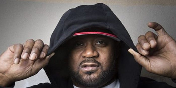 Person wearing a black hoodie and cap.
