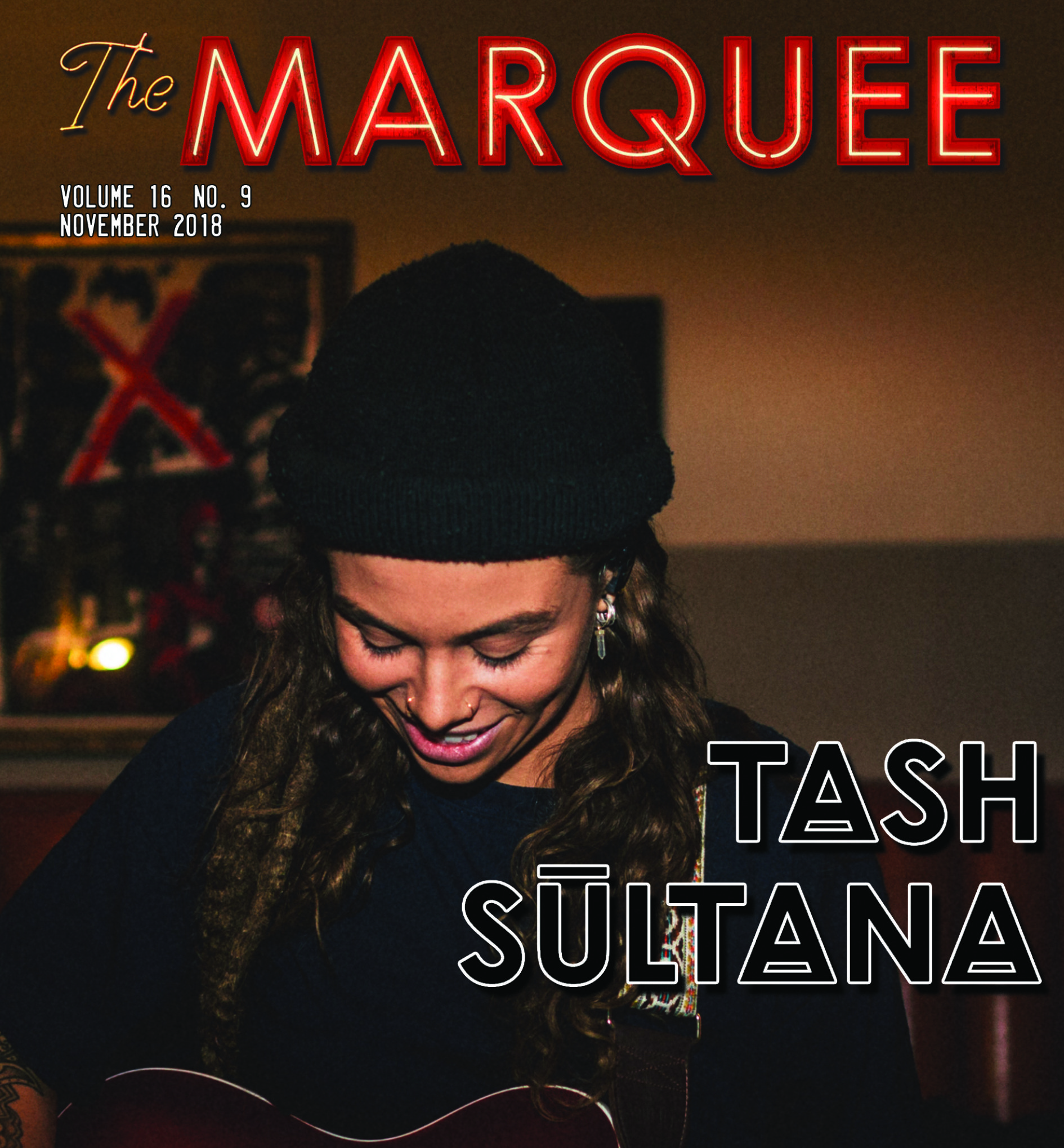 Musician playing guitar on a magazine cover.
