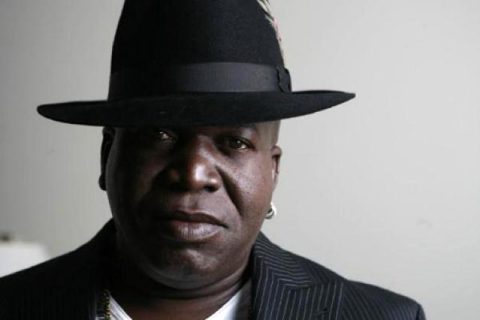 Man wearing a black hat and jacket.
