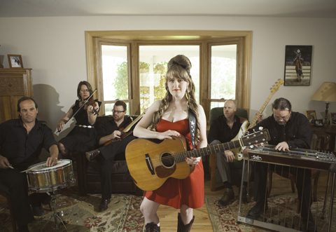 Band with instruments in a living room.