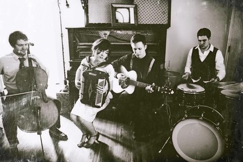 Band performing with accordion and acoustic instruments.