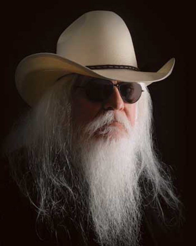 Man with long beard wearing cowboy hat.