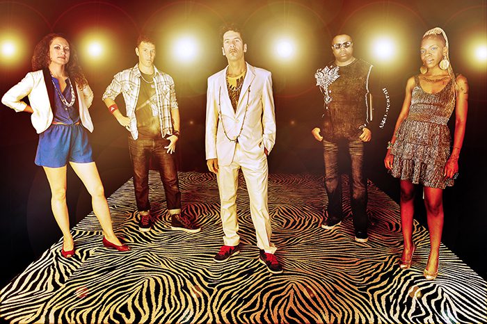 Group posing on zebra-patterned floor.
