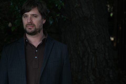 Man standing in front of a tree.
