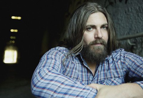 Man with long hair and beard, plaid shirt.