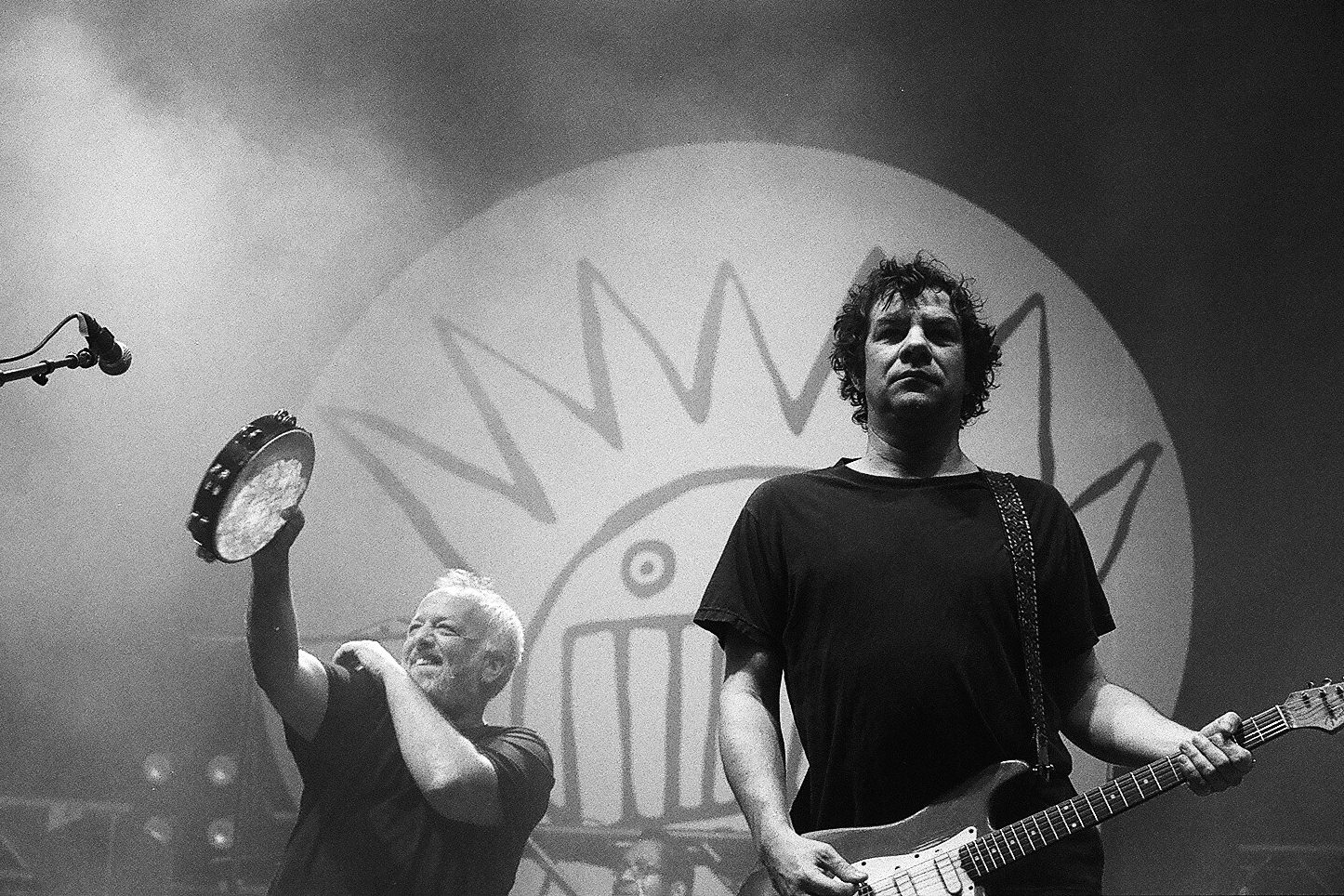 Musicians performing on stage with instruments.