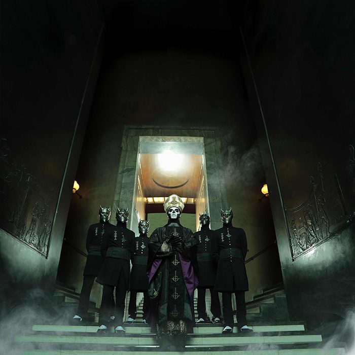 Band in theatrical costumes on stairs.