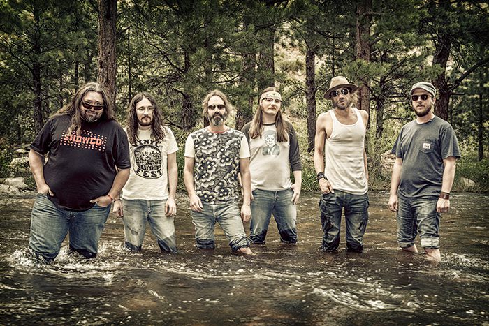 Band standing in a forest stream.