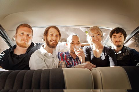 Five people sitting inside a car.