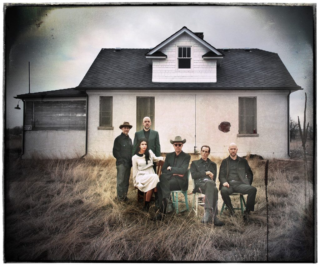 Group sitting outside an old rural house.