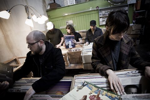 People browsing vinyl records in a store.