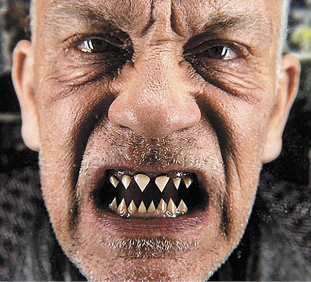 Man with sharp teeth and intense expression.