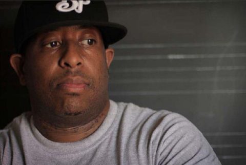 Man wearing a baseball cap, looking aside.