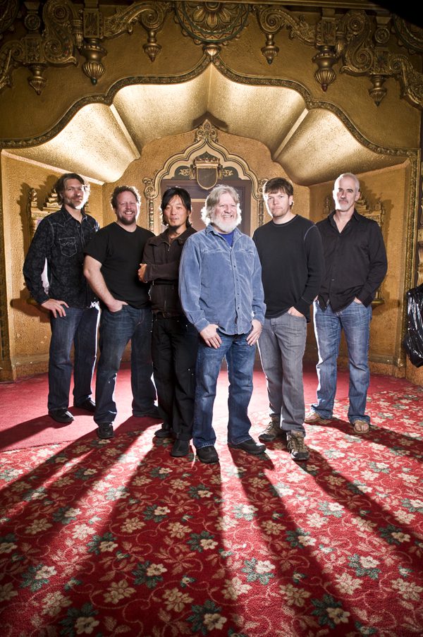 Group of six men in ornate room.