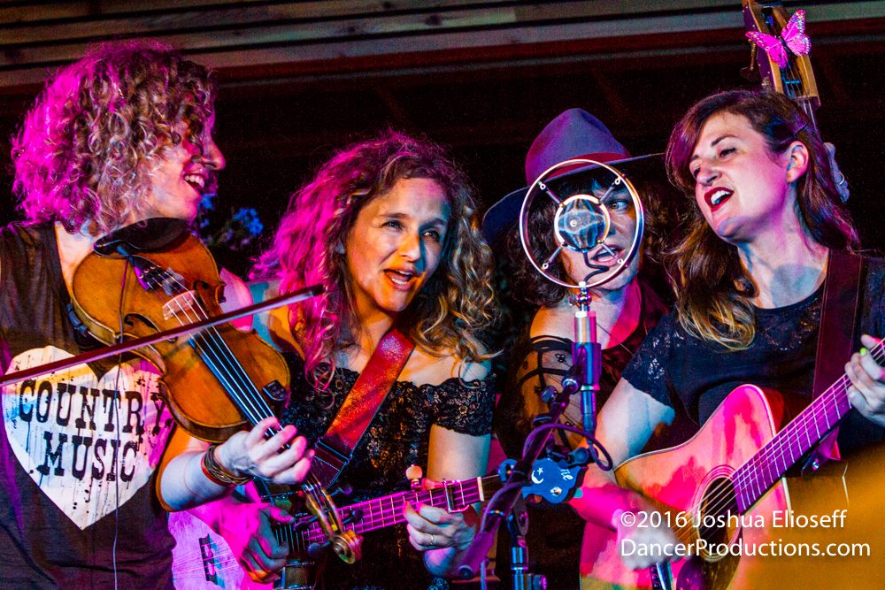 Women performing music with string instruments.