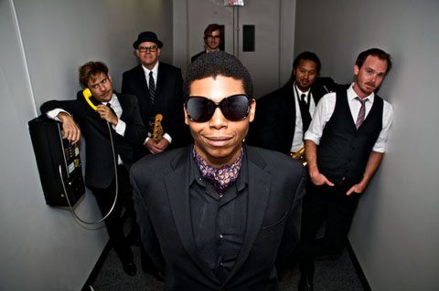 Group of six stylishly dressed musicians.