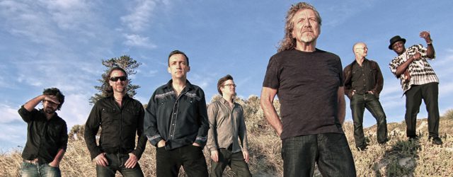 Seven people standing in a desert landscape.