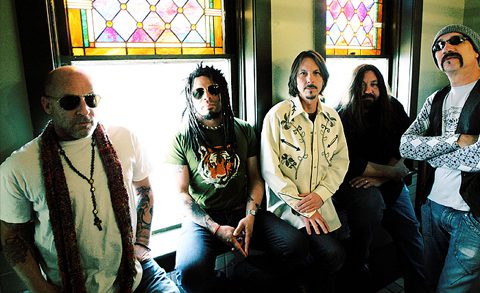 Five men sitting in front of windows.