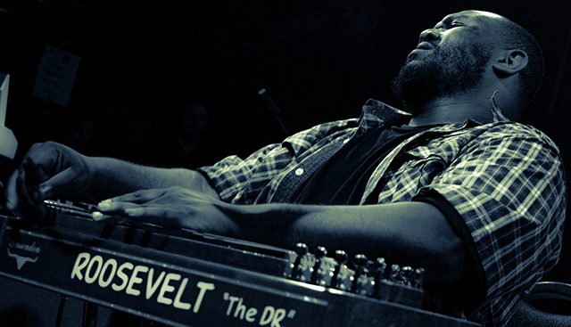 Musician passionately playing a keyboard instrument.