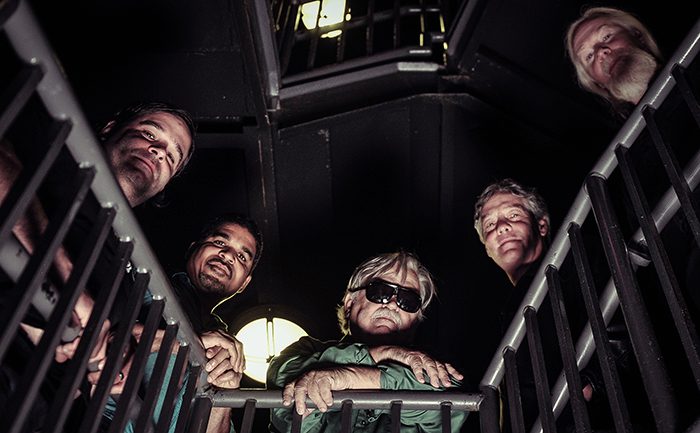 Five people looking up from staircase.