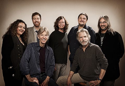 Seven people smiling in a group portrait.