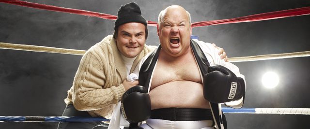 Two men posing in a boxing ring.