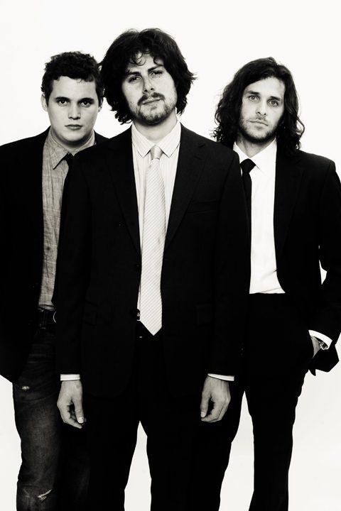 Three men in suits, black and white.