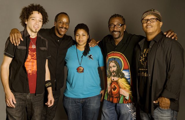 Group of five people posing together.