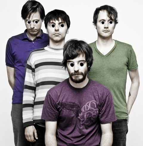Four men with oversized cartoon eyes.