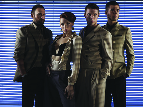 Four people posing in stylish outfits.