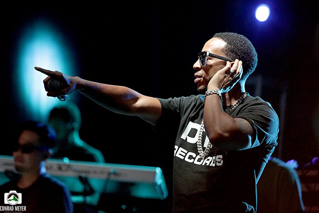 Performer pointing on stage during concert.
