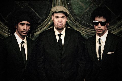 Three men in suits, vintage style portrait.