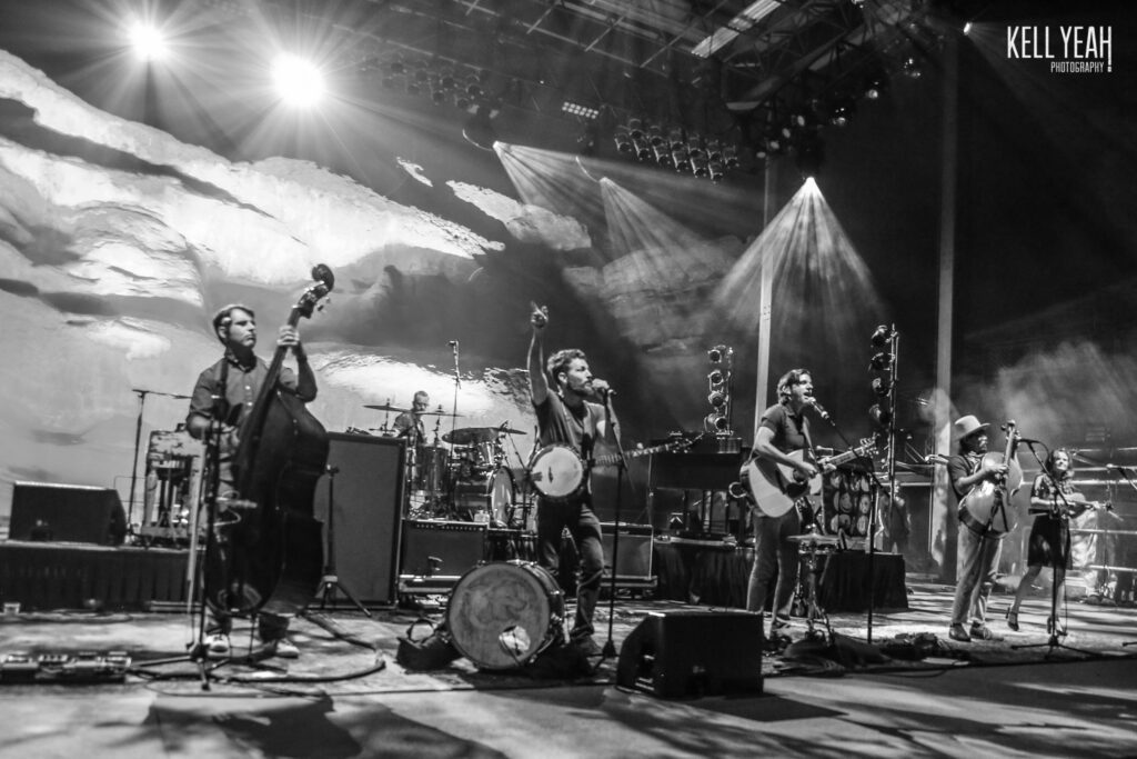 Band performing on stage with instruments.