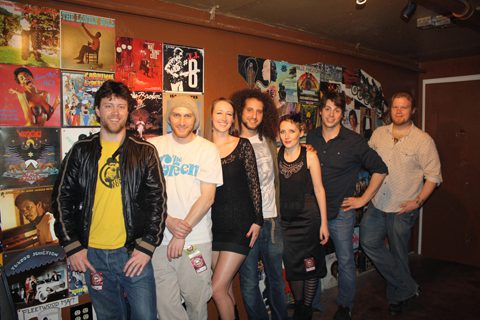 Group of people in front of posters.