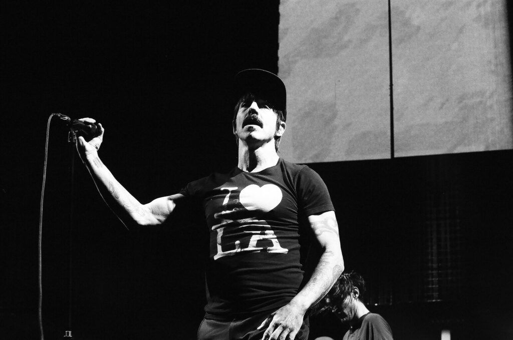 Singer performing on stage with microphone.