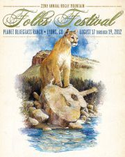 Cougar on giant guitar by water.