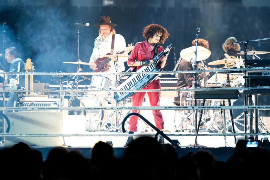 Band performing live on stage with instruments.