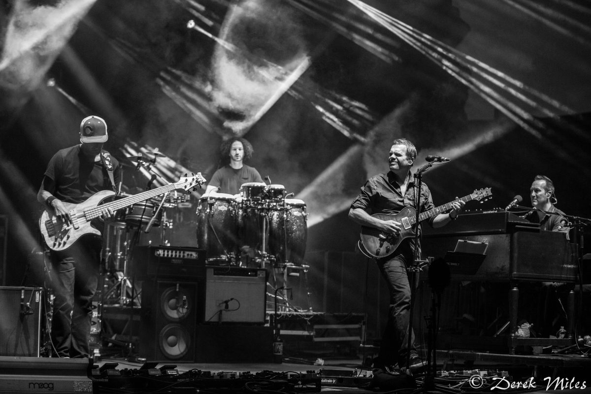 Band performing on stage with instruments.