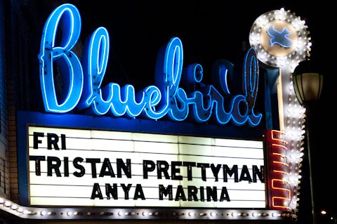 Bluebird Theater marquee with concert names displayed.
