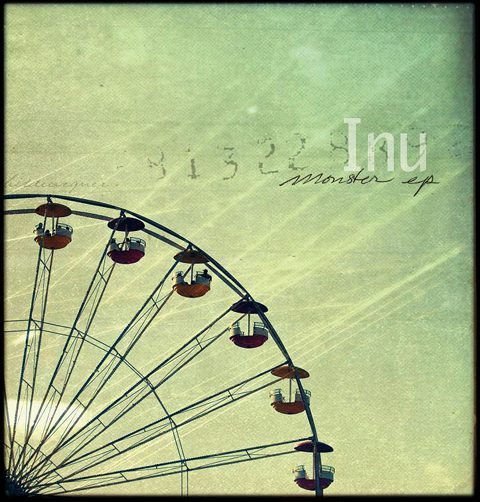 Ferris wheel under a vintage textured sky.