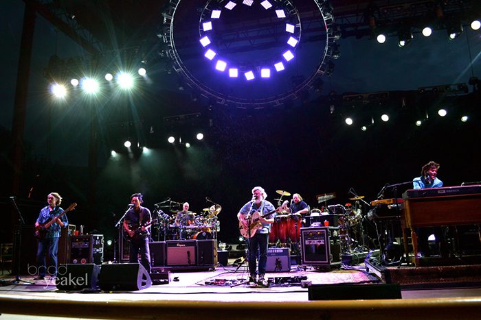Band performing on stage with colorful lights.