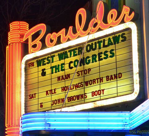 Neon theater marquee with event listings.