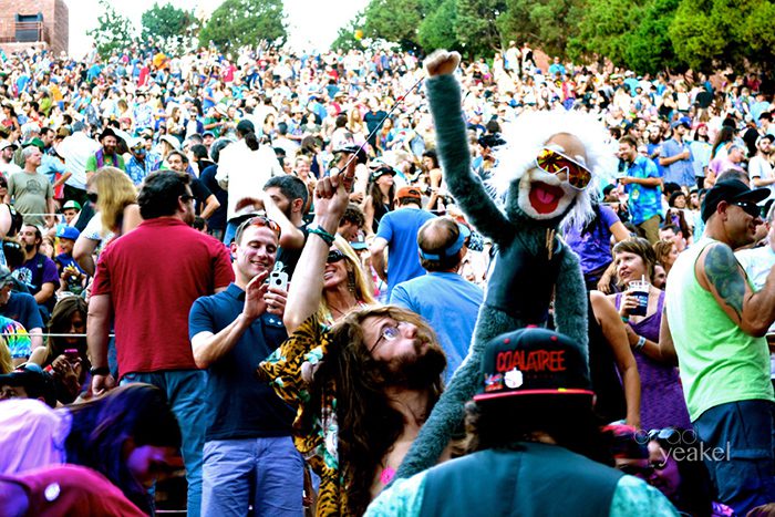 Crowd at outdoor concert with puppet.