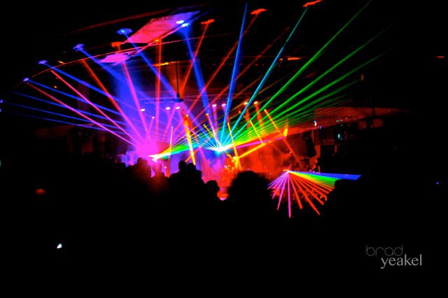 Colorful lasers in a dark concert venue.